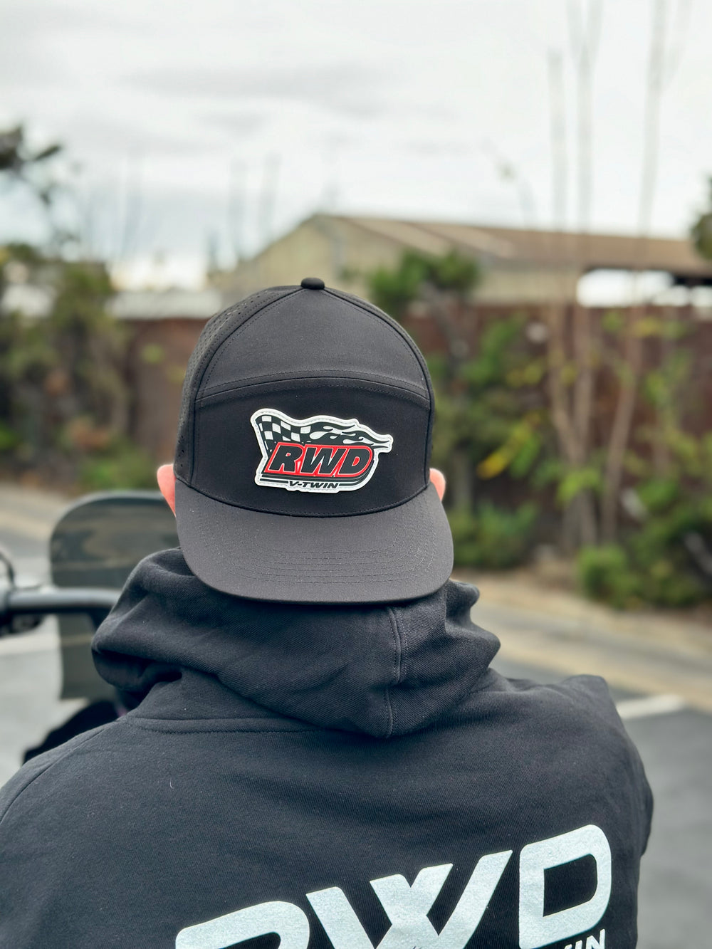 Man wearing an RWD V-Twin hat backwards outdoors
