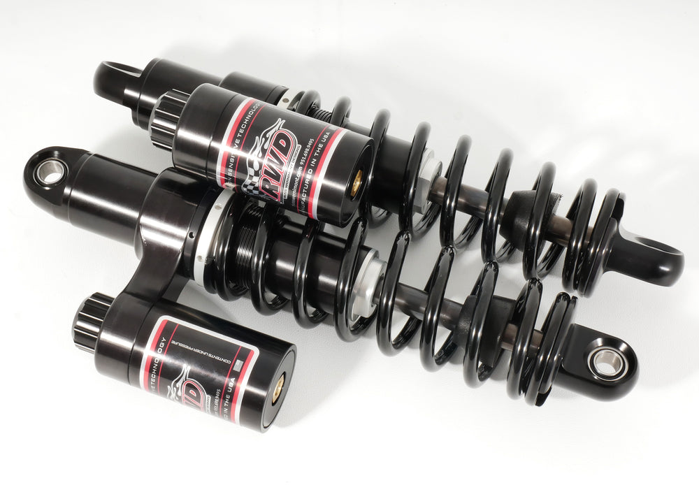 A pair of black RWD V-Twin RS-2 Dyna shocks with exposed springs and reservoirs, designed for motorcycles.